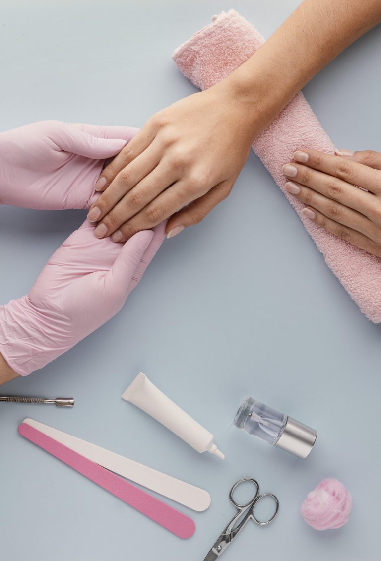 close-up-manicurist-holding-customer-hand